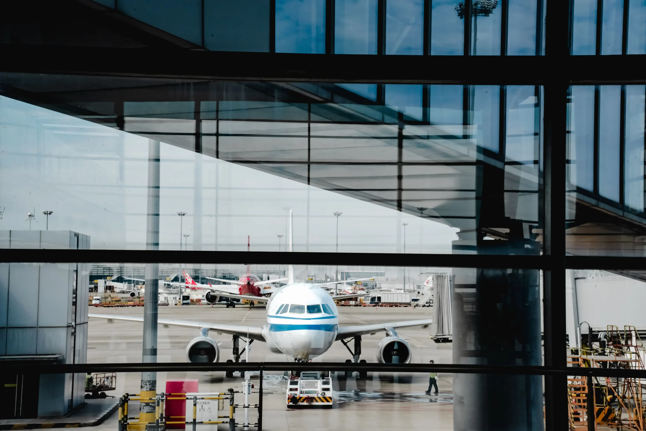 Airport ground operations with baggage carts and staff